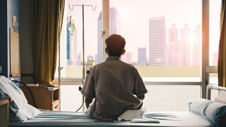 Hospitalized man looking out window