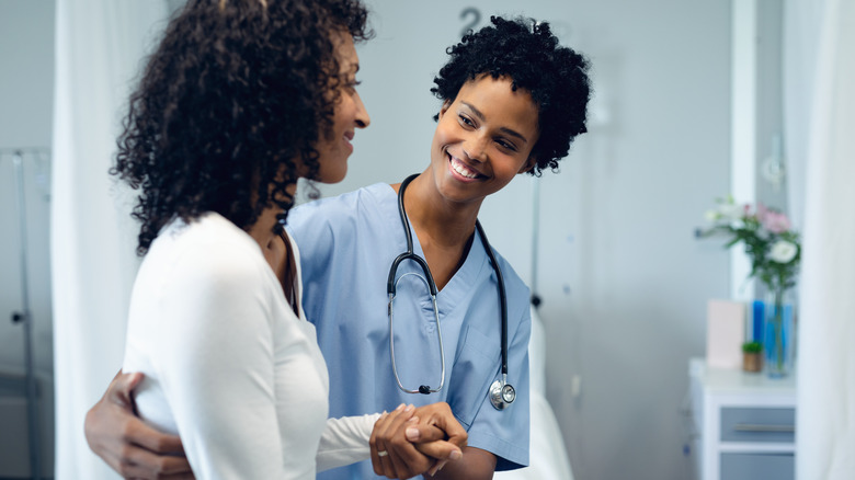 Black woman walking with Black doctor