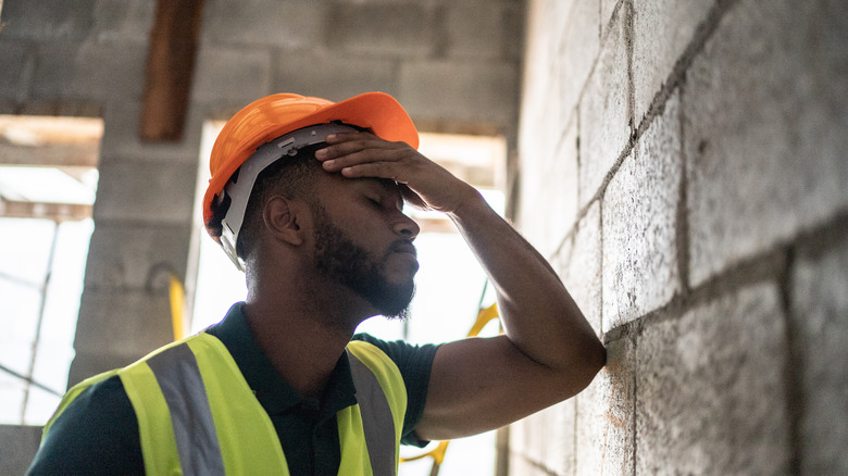 construction working seeking relief in the shade