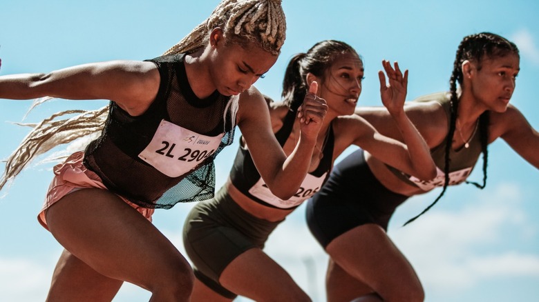 Three female runners racing