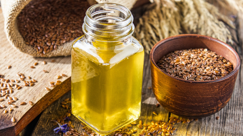 bottle of flax oil with flaxseeds