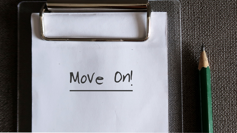 the words "move on" written on a piece of paper
