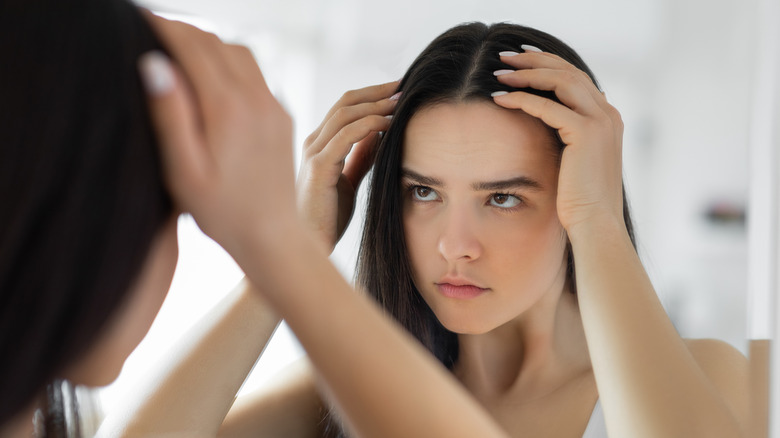 Woman checking for hair loss