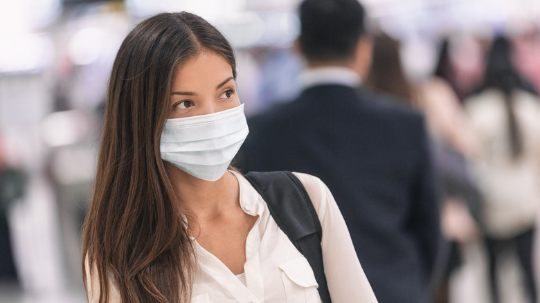 woman wearing a COVID mask in public place indoors