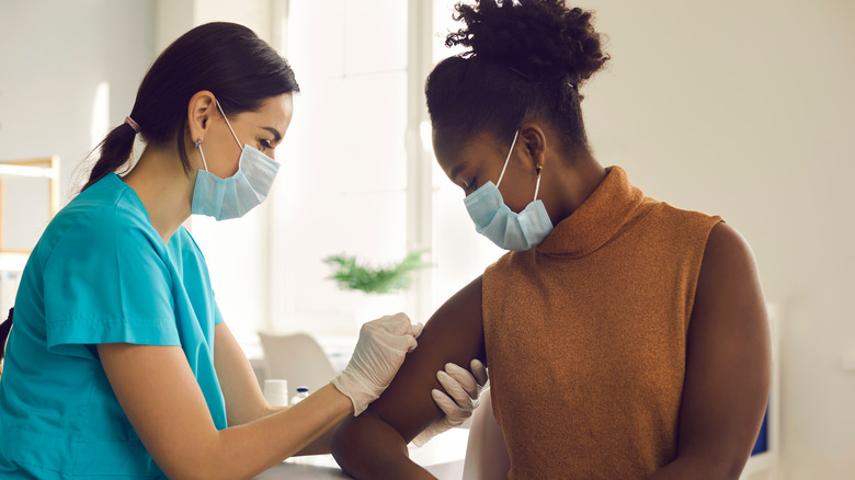 A woman gets a vaccine