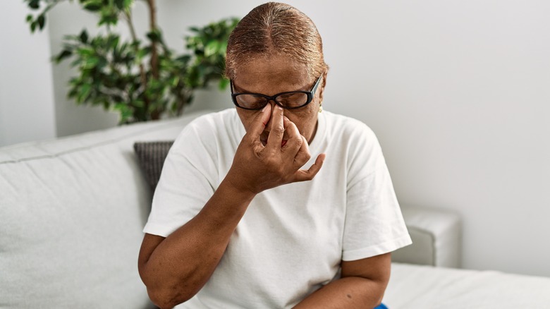Woman rubbing tired eyes