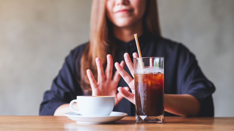 a woman avoiding coffee