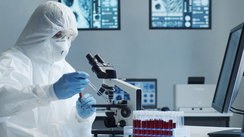 Scientist using microscope in laboratory