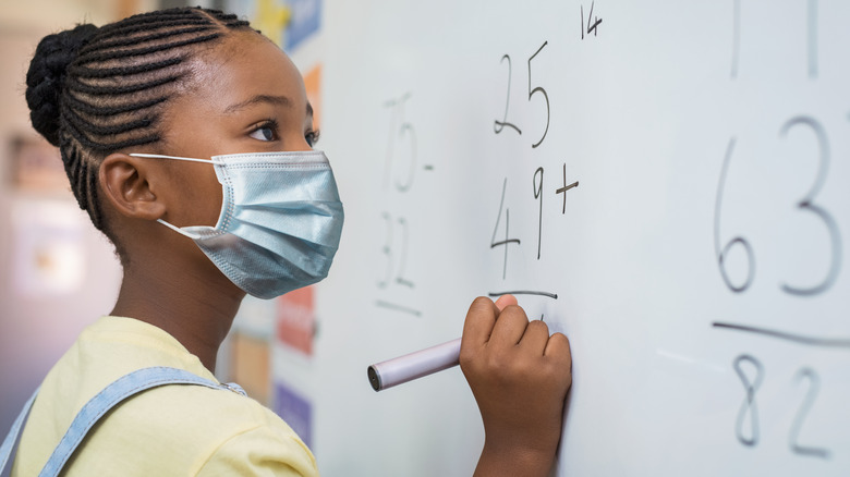 Child wearing a mask in classroom