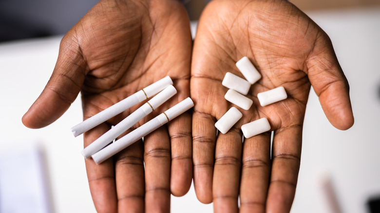 hands holding cigarettes, nicotine gum