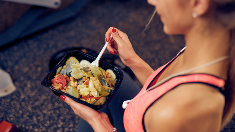 A woman eats after she works out