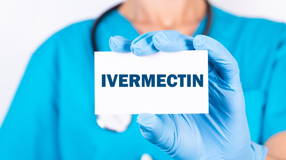 doctor holding ivermectin sign
