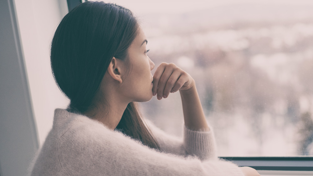 Woman looking out a window