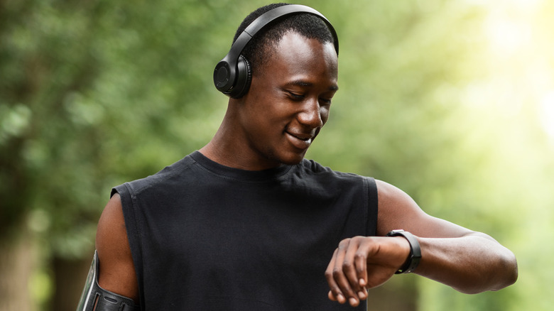 man looking at fitness watch