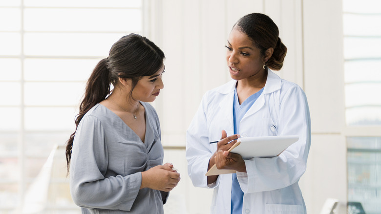 woman doctor talking to female patient