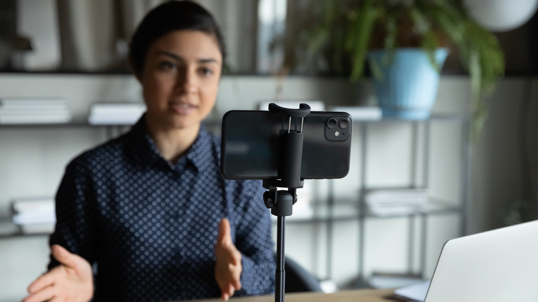 Woman filming a video on her smartphone