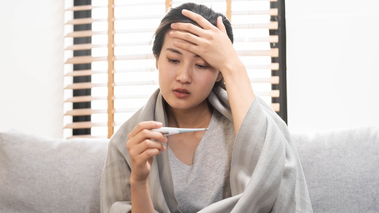 Woman at home feeling with with fever