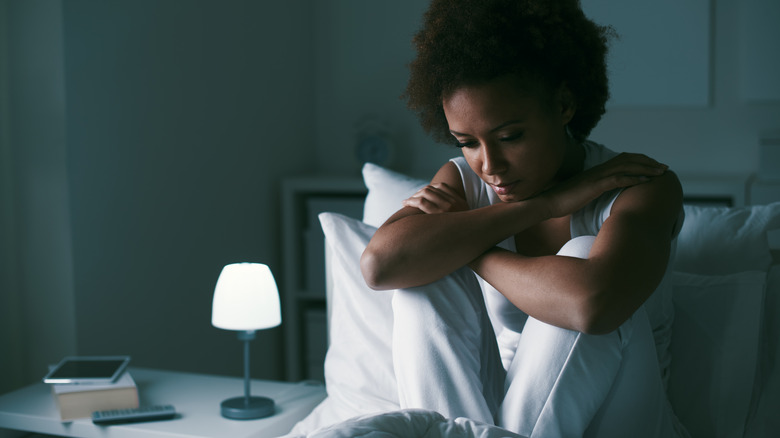 Sad woman awake in bed