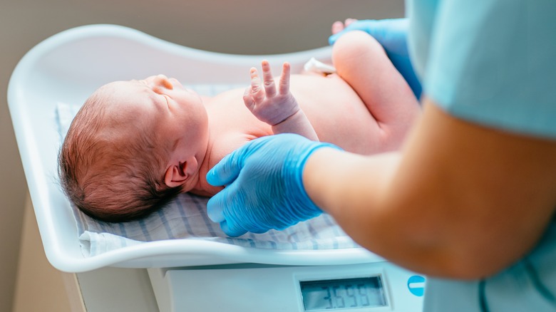 Newborn being weighed