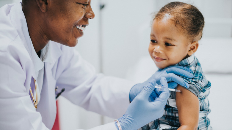 toddler getting vaccinated by pediatrician