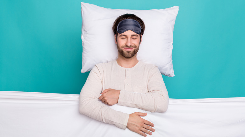 Top view of man happily sleeping