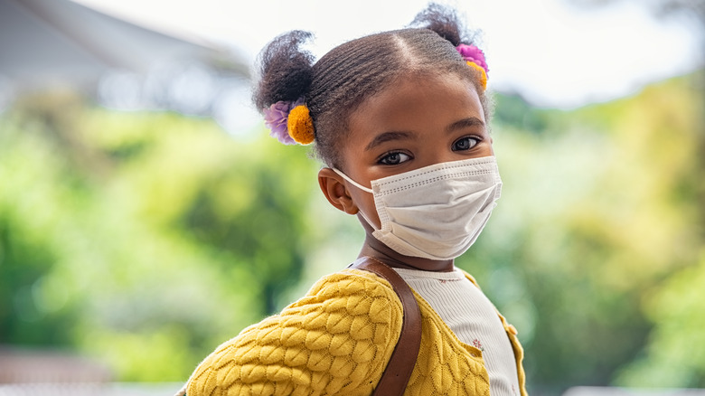 girl under 5 wearing a mask