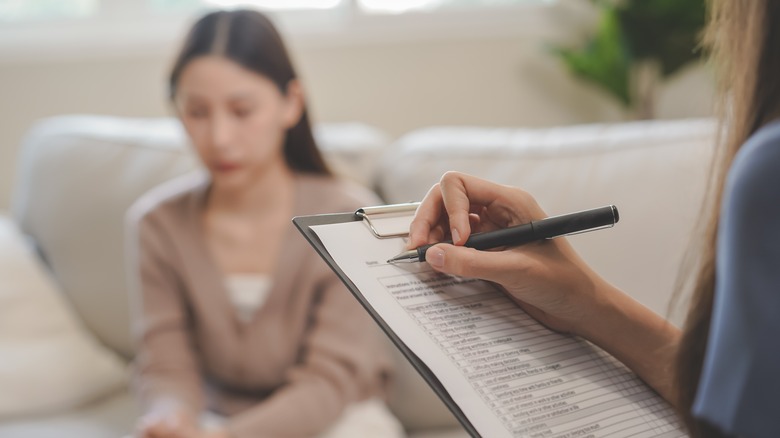 sad asian woman at psychologist office