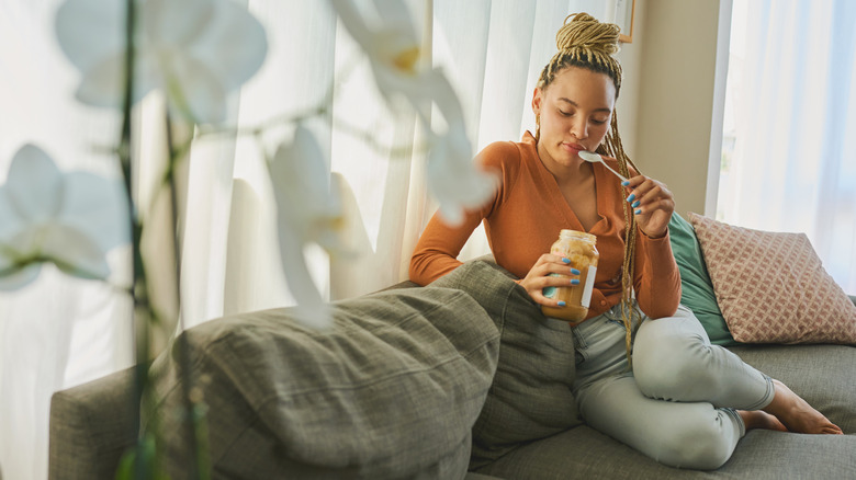 woman eating peanut butter