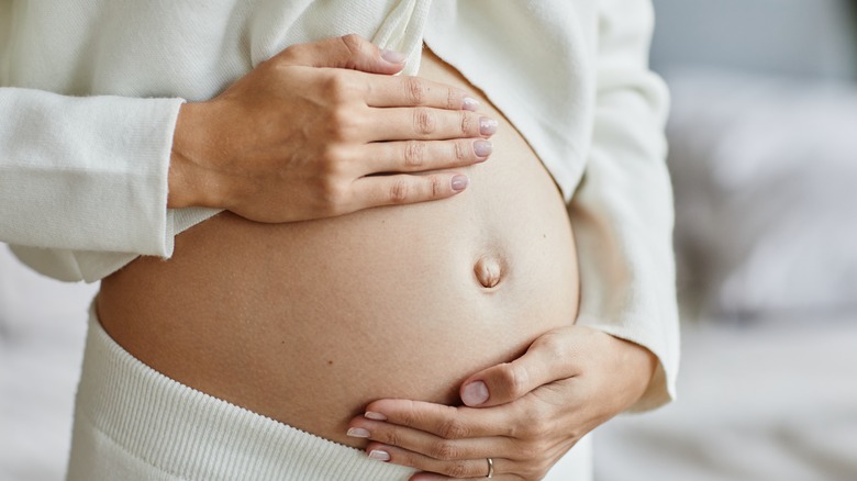 pregant woman holding belly