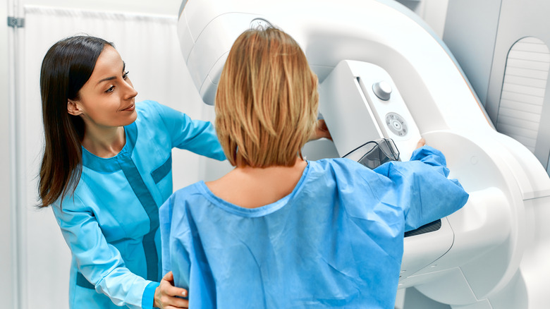 A woman receives a mammogram