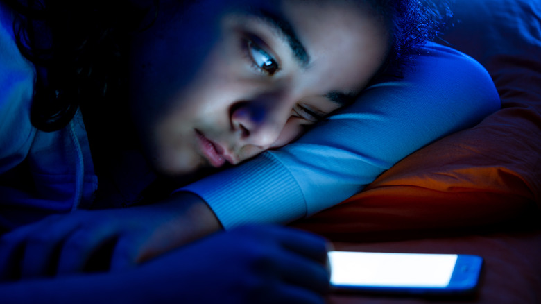 Girl in bed on smartphone