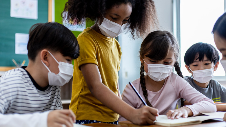 A group of children wear masks in school