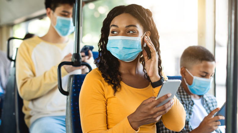 Masked passengers riding bus