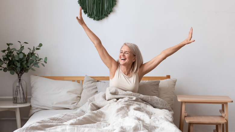A woman wakes up after a good night's sleep