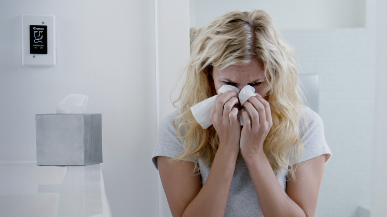 Woman crying in bathroom