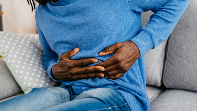 Man placing hands on abdomen