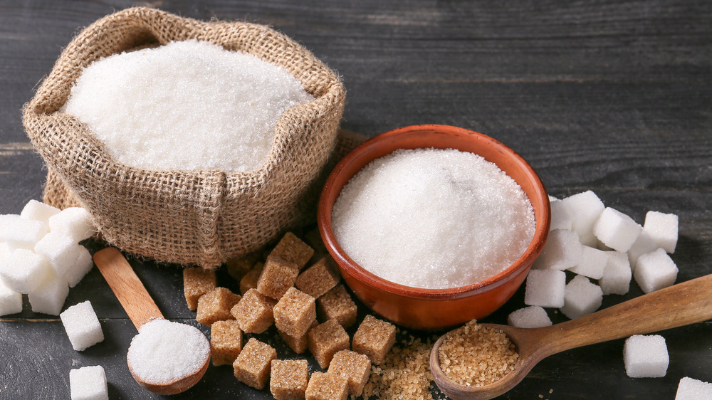 White sugar in a bowl and sugar cubes