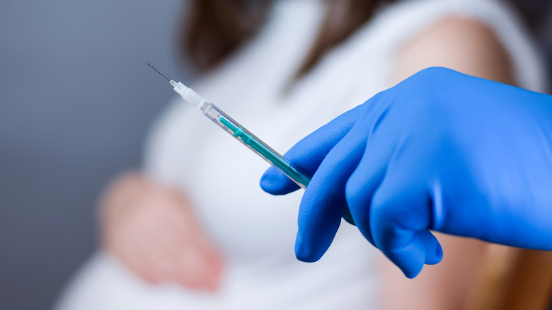 Pregnant woman about to get a COVID-19 vaccine
