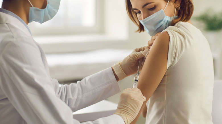 A woman gets the COVID-19 vaccine
