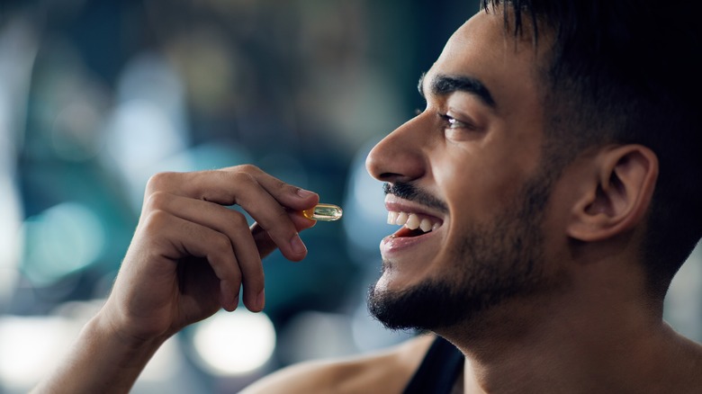 man taking vitamins