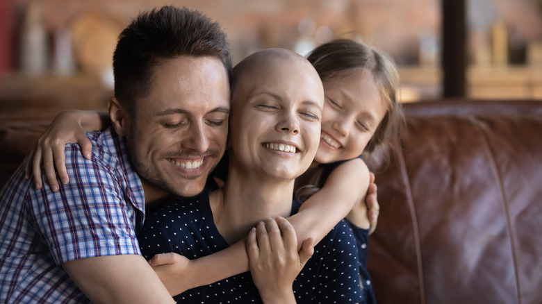 woman with cancer hugging her loved ones