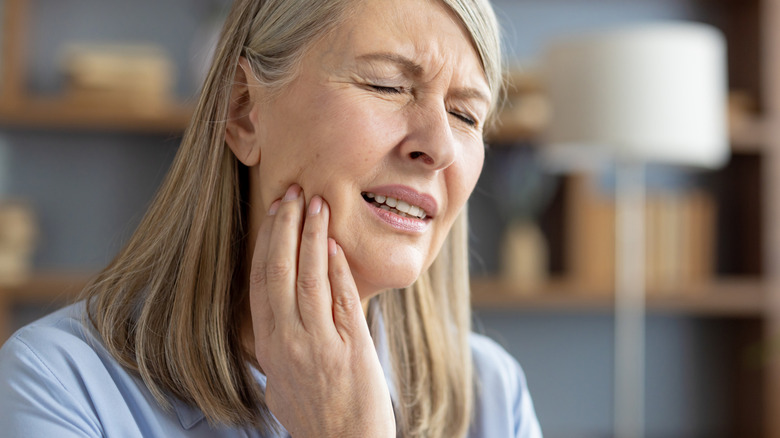 woman sitting at home with toothache