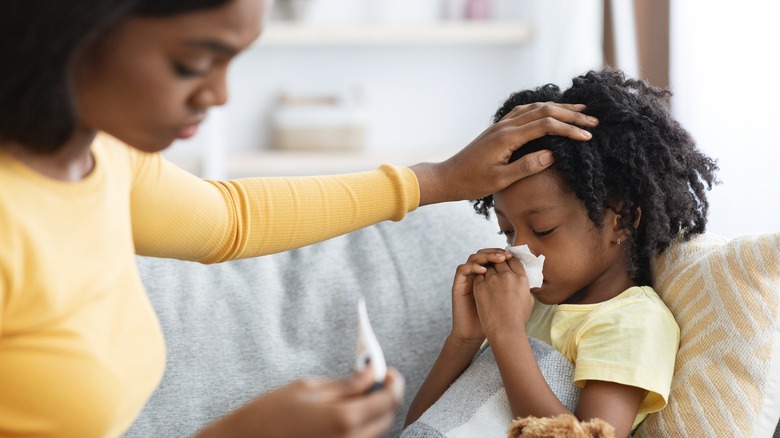 mother taking care of a sick child