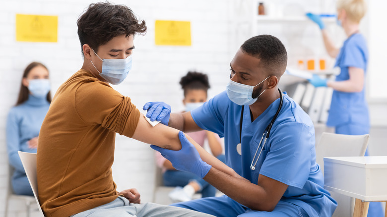 young adult man getting vaccinated
