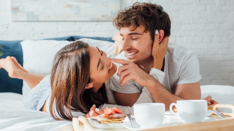 young male and female couple in bed