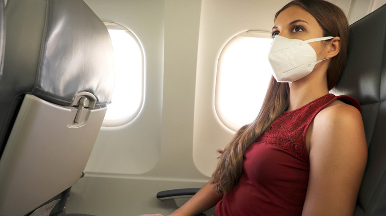 woman wearing mask on plane