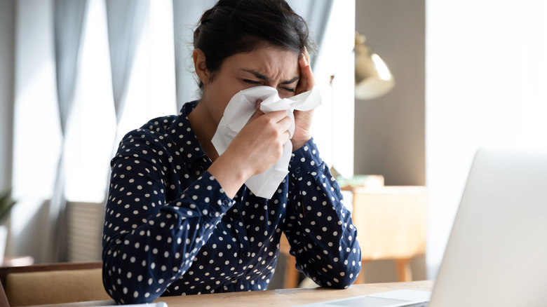 woman blowing mose