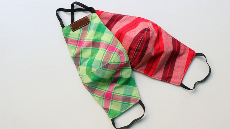 Two brightly colored cloth face masks on white background