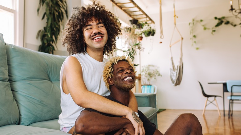 Two men smiling and embracing