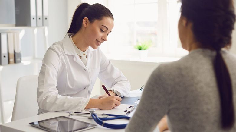 woman talking to doctor about side effects